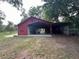 Spacious barn with covered parking, great for storage and agricultural pursuits at 17380 Sweetwater Rd, Dade City, FL 33523