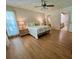 Bright bedroom with a ceiling fan, wood floors, and ensuite bathroom access at 17380 Sweetwater Rd, Dade City, FL 33523