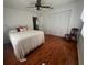 A bedroom with wood floors, a large closet, and a ceiling fan at 17380 Sweetwater Rd, Dade City, FL 33523