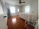 Cozy bedroom with natural light, wood floors, and a ceiling fan at 17380 Sweetwater Rd, Dade City, FL 33523