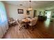 Bright dining room with a classic chandelier, perfect for Gathering meals and entertaining guests in a charming space at 17380 Sweetwater Rd, Dade City, FL 33523