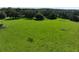 Scenic fenced pasture, with a wooden gate and a backdrop of mature trees at 17380 Sweetwater Rd, Dade City, FL 33523