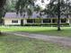 Charming ranch-style home with covered front porch and verdant landscaping at 17380 Sweetwater Rd, Dade City, FL 33523