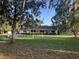 Charming home with manicured lawn and white picket fence at 17380 Sweetwater Rd, Dade City, FL 33523
