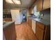 Galley kitchen featuring wood cabinets and white appliances at 17380 Sweetwater Rd, Dade City, FL 33523