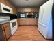 Kitchen area with wood cabinets, wood floors, and plenty of counter space at 17380 Sweetwater Rd, Dade City, FL 33523