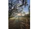 Scenic land with sunlight filtering through trees, ideal for building a private retreat or enjoying nature's beauty at 17380 Sweetwater Rd, Dade City, FL 33523