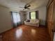 Cozy living room featuring wood floors and a comfortable couch under a ceiling fan at 17380 Sweetwater Rd, Dade City, FL 33523