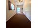 Empty living room with tall ceilings, neutral walls and minimal decor at 17380 Sweetwater Rd, Dade City, FL 33523