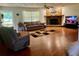 Cozy living room with a stone fireplace, offering a warm and inviting atmosphere with comfortable seating at 17380 Sweetwater Rd, Dade City, FL 33523