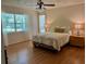 Serene bedroom with a large window, featuring soft lighting and comfortable furnishings for a relaxing retreat at 17380 Sweetwater Rd, Dade City, FL 33523