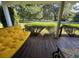 Cozy covered porch with a comfortable swing and outdoor furniture, ideal for relaxation at 17380 Sweetwater Rd, Dade City, FL 33523