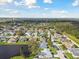 Wide aerial view showcases a neighborhood near a scenic pond at 3118 34Th Avenue E Dr, Bradenton, FL 34208