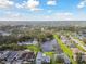 An expansive aerial view of homes surrounding a lake and lush green landscape at 3118 34Th Avenue E Dr, Bradenton, FL 34208