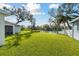 Large, green backyard with a view of the pond and surrounding greenery at 3118 34Th Avenue E Dr, Bradenton, FL 34208