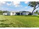 Large, well-manicured backyard and an exterior view of the home at 3118 34Th Avenue E Dr, Bradenton, FL 34208
