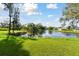 Scenic backyard view showcasing the tranquil lake and lush green space at 3118 34Th Avenue E Dr, Bradenton, FL 34208
