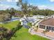Backyard view showcases a lush green lawn, mature tree, patio, and storage shed, creating an inviting outdoor space at 3118 34Th Avenue E Dr, Bradenton, FL 34208