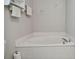 Corner view of a bright bathroom showcasing a bathtub, and neutral-toned walls and flooring at 3118 34Th Avenue E Dr, Bradenton, FL 34208