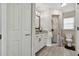 Neutral-toned bathroom featuring a walk-in shower, granite countertops, and a convenient linen cabinet at 3118 34Th Avenue E Dr, Bradenton, FL 34208