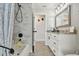 Bathroom view showcasing tiled shower, white vanity with marble counters and modern fixtures at 3118 34Th Avenue E Dr, Bradenton, FL 34208