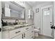 Bathroom featuring a white vanity with marble countertops, modern fixtures, and wood-look tile flooring at 3118 34Th Avenue E Dr, Bradenton, FL 34208