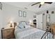 Cozy bedroom with ceiling fan, wood-look flooring, and neutral decor with dual nightstands and bedside lamps at 3118 34Th Avenue E Dr, Bradenton, FL 34208