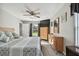 Bright bedroom with neutral tones, a ceiling fan, wood furnishings, and an outside view from the window at 3118 34Th Avenue E Dr, Bradenton, FL 34208