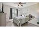 Comfortable bedroom with wood-look flooring, window, and neutral decor with nightstands and bedside lamps at 3118 34Th Avenue E Dr, Bradenton, FL 34208