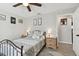 Bedroom with ceiling fan, wood-look flooring, and neutral decor with nightstands and bedside lamps at 3118 34Th Avenue E Dr, Bradenton, FL 34208