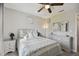 Bedroom with wood-look flooring, ceiling fan, and neutral decor with dual nightstands and bedside lamps at 3118 34Th Avenue E Dr, Bradenton, FL 34208