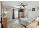 This bedroom features a ceiling fan, closet, dresser, wood-look tile floors, and a window with gray drapes at 3118 34Th Avenue E Dr, Bradenton, FL 34208