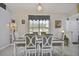 Dining room with gray wood floors, a chandelier, and seating for six at 3118 34Th Avenue E Dr, Bradenton, FL 34208