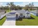 Charming home with a well-manicured lawn, large driveway, and serene water view at 3118 34Th Avenue E Dr, Bradenton, FL 34208