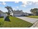 Well-maintained home with lush green lawn and long driveway leading to a two-car garage at 3118 34Th Avenue E Dr, Bradenton, FL 34208