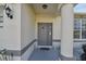 Inviting front entryway features decorative columns and a charming, gray front door at 3118 34Th Avenue E Dr, Bradenton, FL 34208