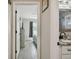 Hallway featuring wood-look tile floors with view of bedroom and gray curtains and bathroom vanity at 3118 34Th Avenue E Dr, Bradenton, FL 34208
