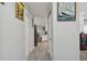 Hallway featuring gray wood floors, a view into the kitchen, and white walls at 3118 34Th Avenue E Dr, Bradenton, FL 34208