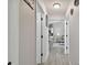 Hallway with view into kitchen and living room. Features wood-look floors and a ceiling fan at 3118 34Th Avenue E Dr, Bradenton, FL 34208