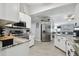 Modern kitchen with stainless steel appliances, marble countertops, white cabinets, and ample natural light at 3118 34Th Avenue E Dr, Bradenton, FL 34208