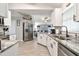 Bright kitchen features stainless appliances, gray counters and white cabinets at 3118 34Th Avenue E Dr, Bradenton, FL 34208