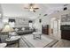 Spacious living room with gray sofa, patterned rug, and vaulted ceiling at 3118 34Th Avenue E Dr, Bradenton, FL 34208