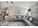 Open living room with gray sofa, patterned rug, and view to kitchen at 3118 34Th Avenue E Dr, Bradenton, FL 34208