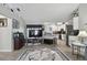 Open-concept living room with wood floors, kitchen access, and large TV viewing area at 3118 34Th Avenue E Dr, Bradenton, FL 34208