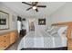 Comfortable main bedroom featuring a ceiling fan, neutral walls, and wood flooring at 3118 34Th Avenue E Dr, Bradenton, FL 34208