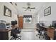 A home office featuring a window with a view, gray floors, and two desks at 3118 34Th Avenue E Dr, Bradenton, FL 34208