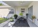 Covered patio featuring a table and chairs, potted plants, and an outdoor rug at 3118 34Th Avenue E Dr, Bradenton, FL 34208