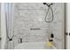 Elegant shower with marble-look tiling and a black shower head at 3118 34Th Avenue E Dr, Bradenton, FL 34208
