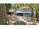 The house has a screened-in porch, mature trees, and a lush yard at 7214 Oakwood Dr, New Port Richey, FL 34652