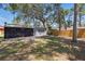 Private backyard with plenty of shade and a wooden fence at 7214 Oakwood Dr, New Port Richey, FL 34652